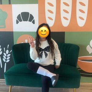 White Sweater with Black Bow Design